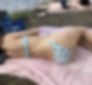 Girl in Swimsuit Lying on a Towel at a Lake Beach Hot Photos