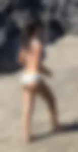 Beautiful brunette teen babe on the beach with a perfect body