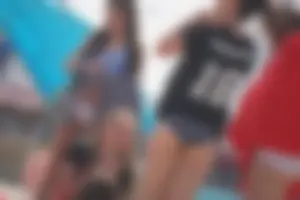 A group of teens in bikinis on the beach