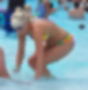 Blonde milf with a sexy body in bikini at the pool