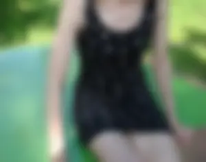 A skinny flat-chested blonde wife in a dress with very white skin at the playground