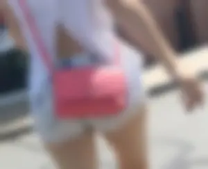 Sexy babe in short jeans shorts on the phone