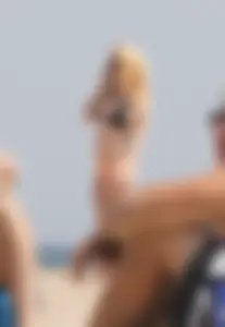 Hot blonde in peach and black bikini on the beach