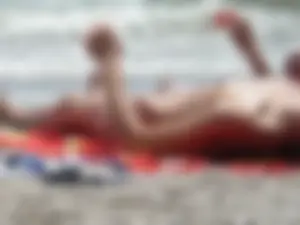 Sexy topless girl on the beach in a thong bikini
