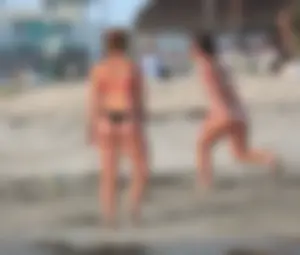 Thick white girls ass in a black thong bikini at the beach