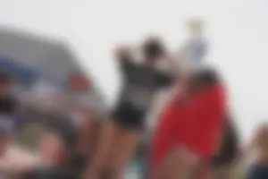 A group of teens in bikinis on the beach