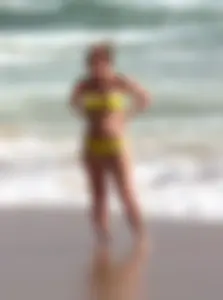 Big booty white girl in a yellow bikini at the beach