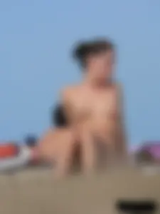 Sexy babe with a nice body topless and in a thong on the beach