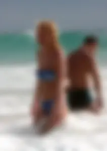 Blonde milf in a blue bikini looking sexy at the beach