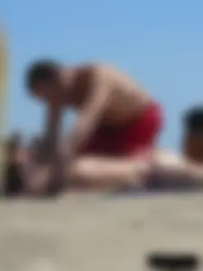 Purple thong topless lady on the beach gets oiled up by her husband