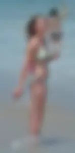Milf at the beach in the water with hard nipples and a nice body
