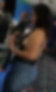 Thick brunette in tight jeans and showing some side boob