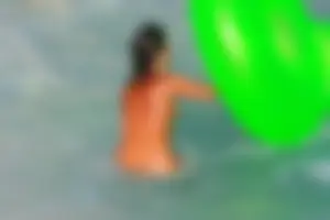 FKK Nudists playing in the water with floater