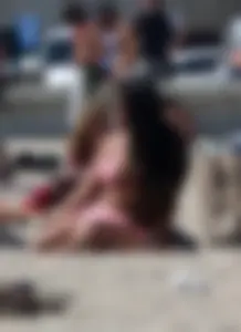 Sexy brunette on the beach in a bikini with great tits