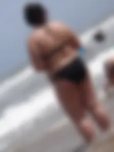 Thick beach girl in black bikini with big ass and tits