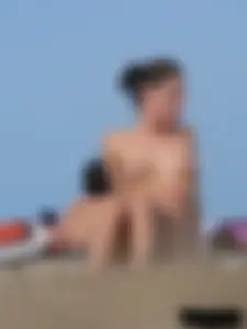 Sexy babe with a nice body topless and in a thong on the beach