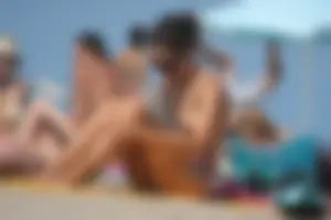 2 topless girls at the beach in thongs