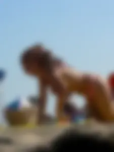 Topless tattooed lady at the beach with a nice ass in pink thong bikini