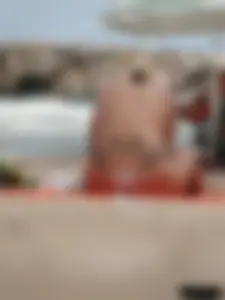 Tattooed blonde with big tits topless and in thong