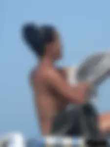 Hot ass topless beach girl with great tits lets her little brother oil up her ass in thong bikini
