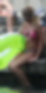 Blonde bikini girl at the pool in pink bikini top with amazing tits
