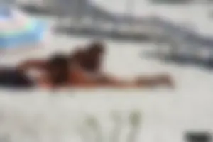 Topless milf and her topless daughter on the beach