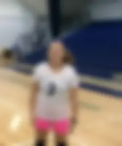 Bunch of cute college girls in bright pink shorts playing volleyball