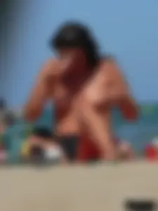 Bunch of sexy babes on the beach topless and in thong bikinis