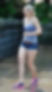Cute blonde in denim shorts and a wet top