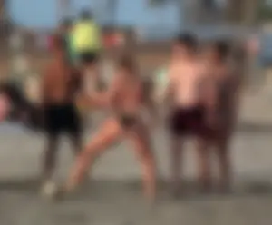 Thick white girls ass in a black thong bikini at the beach