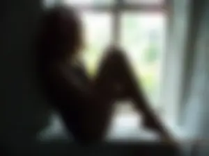Young And Skinny Barefoot Girl in Panties Sitting on the Windowsill of a Country House