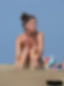 Sexy babe with a nice body topless and in a thong on the beach