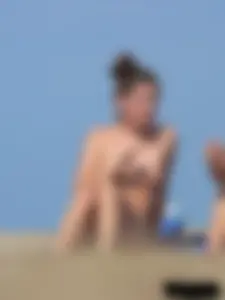 Sexy babe with a nice body topless and in a thong on the beach