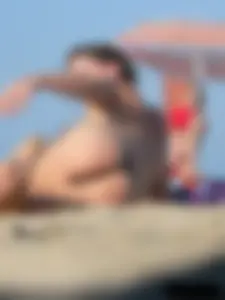 Sexy babe with a nice body topless and in a thong on the beach