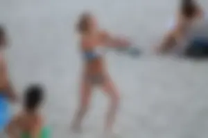 Sexy girl playing beach volleyball in a bikini