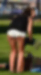 Sexy blonde girl in the park playing volleyball in her skimpy bikini