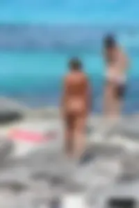 Older lady on a nude beach showing her body