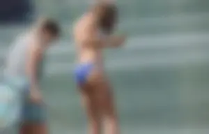 Skinny teen having fun in her little England bikini