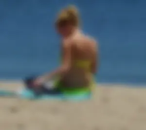 Sexy ass blonde milf on the beach in a thong with cameltoe and bending over