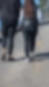 A beautiful little brunette walking in the park. tight black leggings