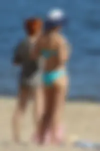 Couple of hot babes hanging out at the beach in bikinis
