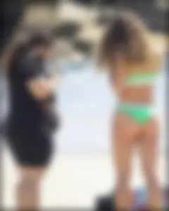 Super hot beach babe with a perfect body in a green thong bikini