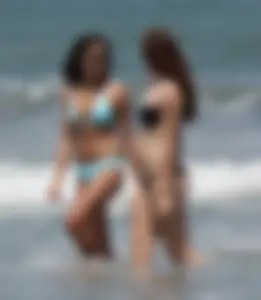 Brunette and redhead on the beach in bikinis looking sexy