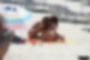 Topless milf and her topless daughter on the beach