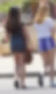Sexy teen with glasses showing ass cheeks in shorts and friend in tight dress