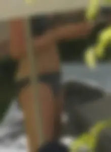 Skinny girl laying out in her bikini has pussy lip slip