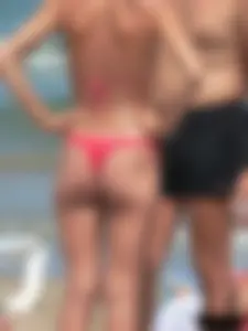 A bunch of hot babes on the beach in thong bikinis