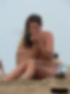 Sexy babe with a nice body topless and in a thong on the beach