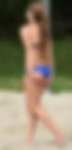 Cute girl playing volleyball in her little bikini