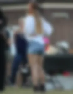 Hippie type dressed girl in denim shorts with a nice ass